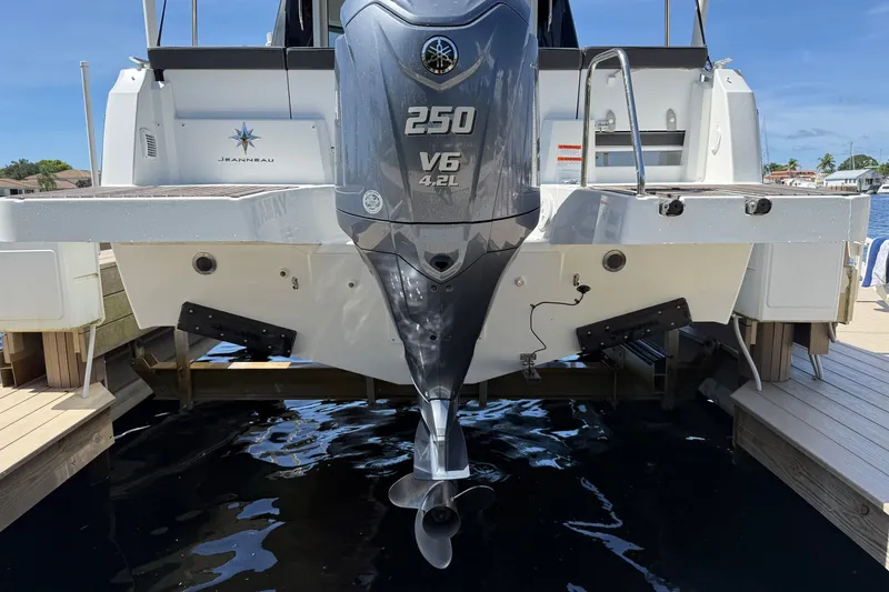 Slide: The Image of 2022 Jeanneau NC 795 Series 2 boat with powerful 250 V6 engine docked at marina. - 27