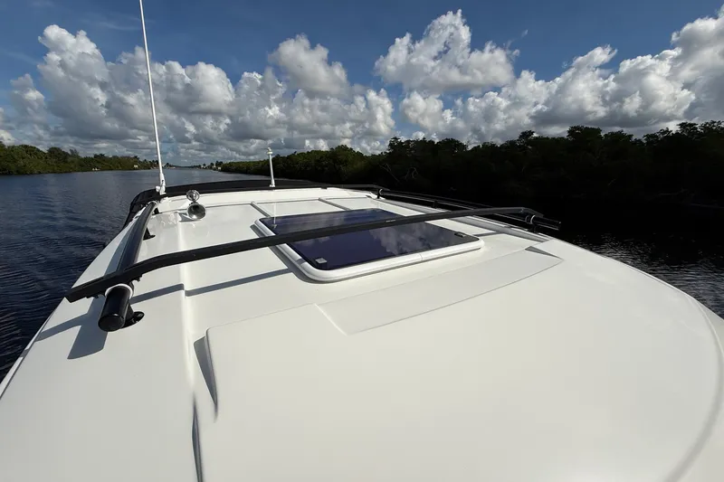 Slide: The Image of 2022 Jeanneau NC 795 Series 2 boat on calm water under a cloudy sky. - 8