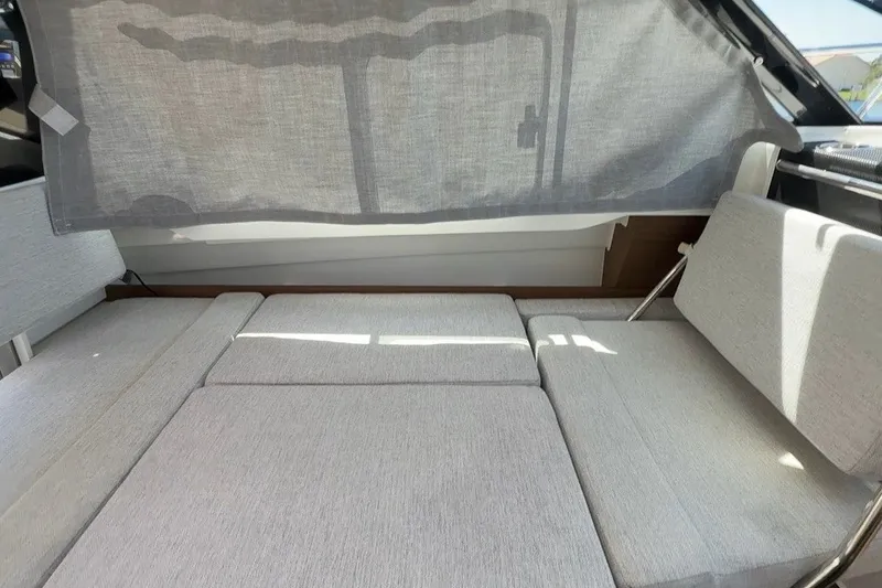 Slide: The Image of Interior seating area of 2022 Jeanneau NC 795 Series 2 boat with light gray upholstery. - 17