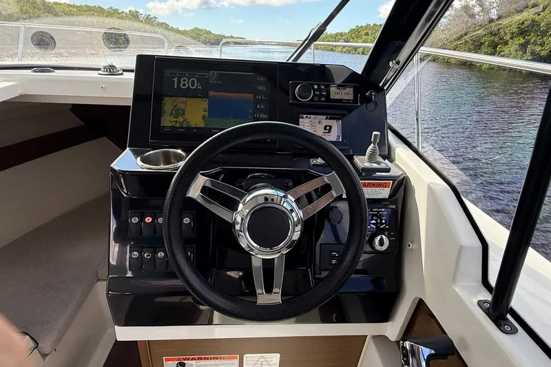 Slide: The Image of Steering console of 2022 Jeanneau NC 795 Series 2 boat with navigation display. - 9
