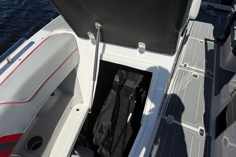 Slide: The Image of Open storage compartment on 2024 Regal LX9 boat, showcasing interior details and seating. - 20
