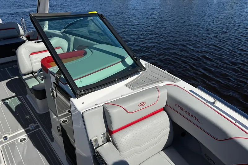 Slide: The Image of 2024 Regal LX9 boat interior with sleek seating and modern design on the water. - 16