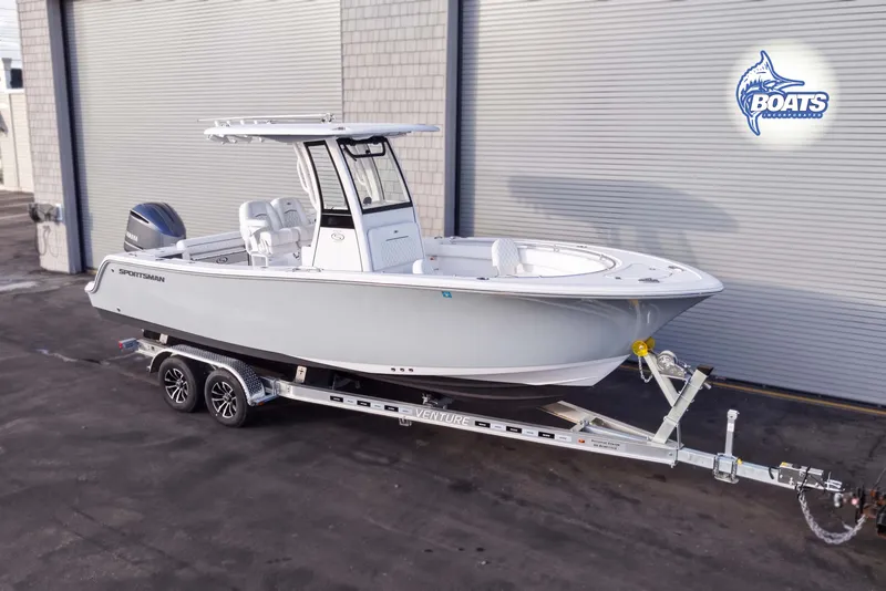 The Image of 2025 Sportsman Open 232 Center Console boat on trailer, parked outdoors. - 0