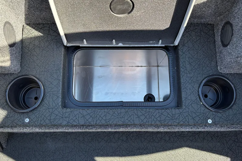 Slide: The Image of 2027 Tracker Pro Team 195 boat interior with open storage compartment and cup holders. - 35