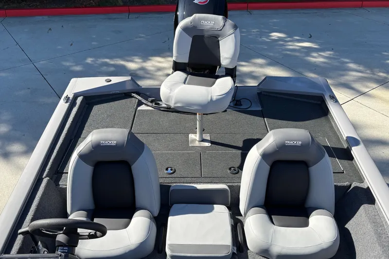 Slide: The Image of 2027 Tracker Pro Team 195 boat interior with three gray seats on deck. - 15