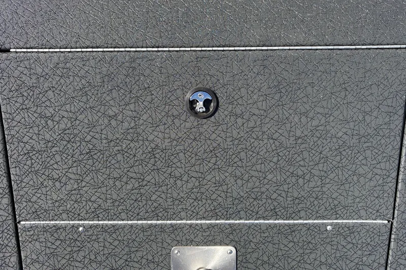 Slide: The Image of Textured surface of a 2027 Tracker Pro Team 195 boat with a lock mechanism. - 30