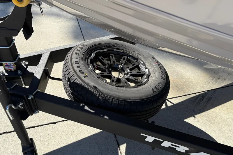 Slide: The Image of 2027 Tracker Pro Team 195 trailer with Loadstar tire on concrete surface. - 44