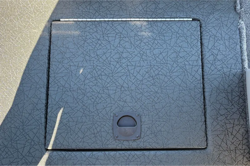 Slide: The Image of Hinged compartment on 2027 Tracker Pro Team 195 boat deck. - 36
