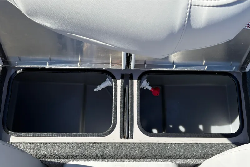 Slide: The Image of Storage compartments in a 2027 Tracker Pro Team 195 boat, featuring dual lids and drainage plugs. - 42