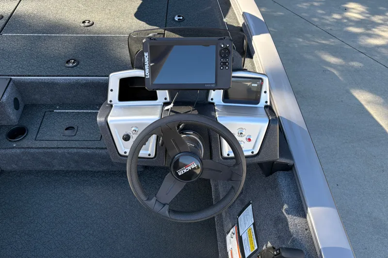 Slide: The Image of 2027 Tracker Pro Team 195 boat dashboard with steering wheel and navigation display. - 21