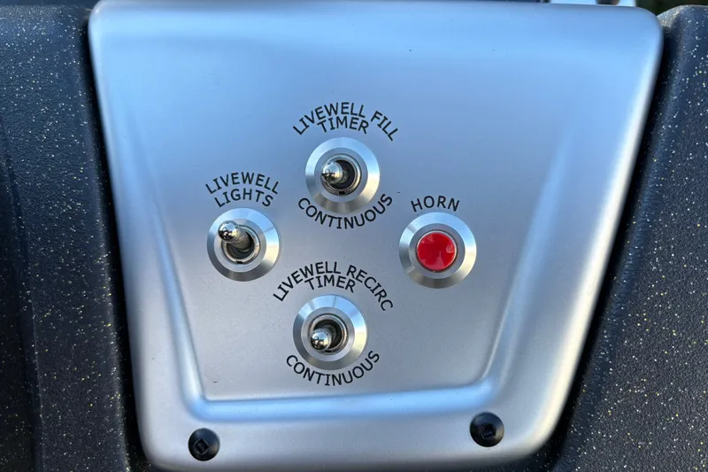 Slide: The Image of Control panel of 2027 Tracker Pro Team 195 boat with switches and horn button. - 29