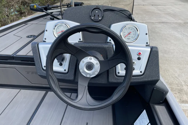 Slide: The Image of Steering wheel and dashboard of 2027 Tracker Pro 170 boat, featuring gauges and controls. - 15