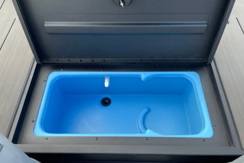 Slide: The Image of Open storage compartment in 2027 Tracker Pro 170 boat, featuring a blue interior. - 22