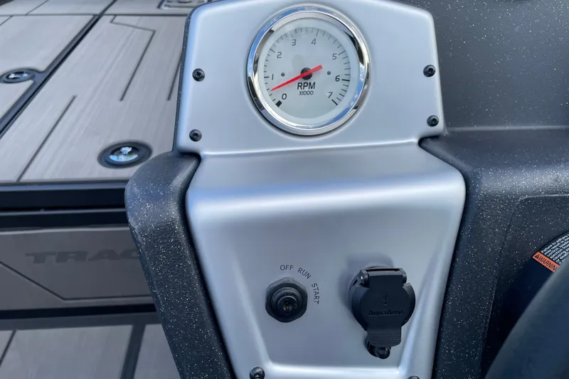 Slide: The Image of 2027 Tracker Pro 170 dashboard with RPM gauge and ignition switch. - 17