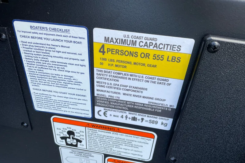 Slide: The Image of Tracker Pro 170 boat capacity label, 2027 model, U.S. Coast Guard compliance, 4 persons or 555 lbs. - 24