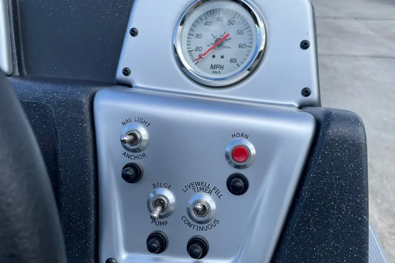 Slide: The Image of Control panel of 2027 Tracker Pro 170 boat with speedometer and switches. - 16