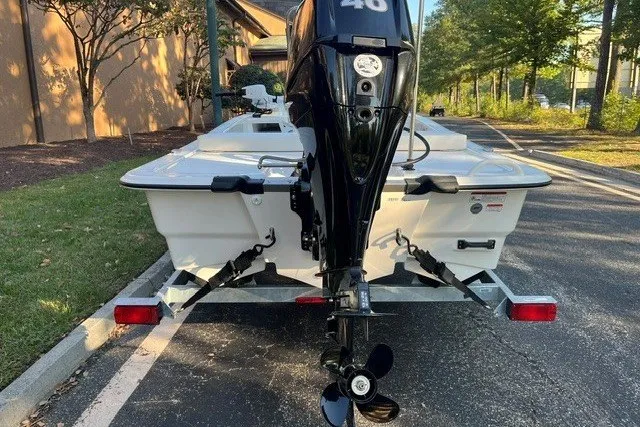 Slide: The Image of 2026 Mako Pro Skiff 13 CC boat on trailer, rear view with outboard motor. - 4