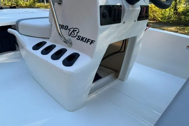 Slide: The Image of 2026 Mako Pro Skiff 13 CC boat console with rod holders and storage compartment. - 12
