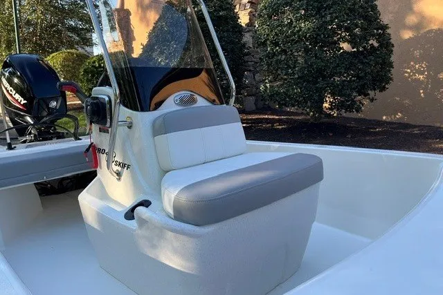 Slide: The Image of 2026 Mako Pro Skiff 13 CC boat with center console and cushioned seating. - 5