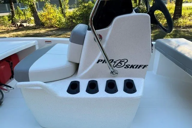 Slide: The Image of 2026 Mako Pro Skiff 13 CC boat console with seating and rod holders. - 7