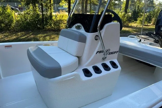 Slide: The Image of 2026 Mako Pro Skiff 13 CC boat interior with cushioned seating and steering console. - 11