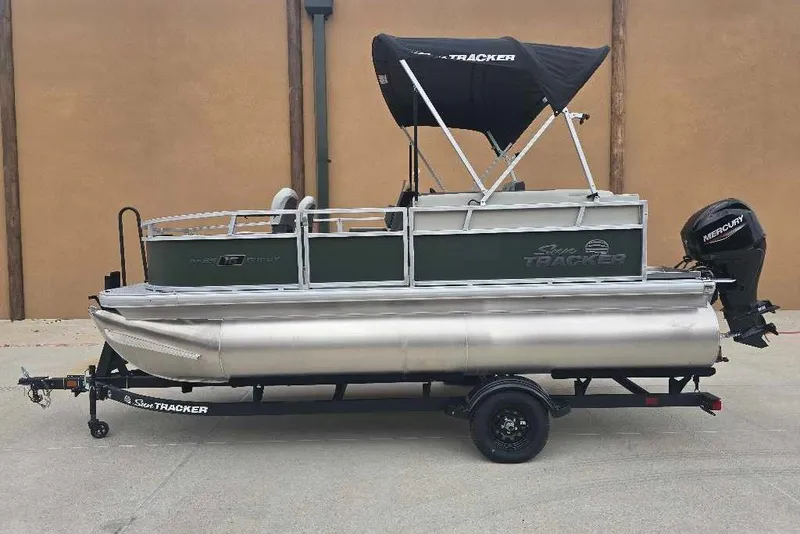 The Image of 2027 Sun Tracker Bass Buggy 16 XL Select pontoon boat on trailer, side view. - 0