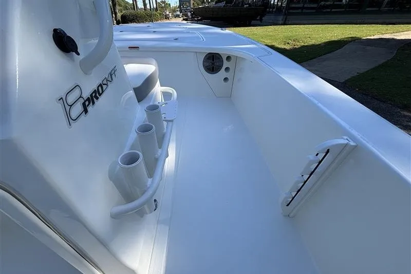 Slide: The Image of 2026 Mako 18 Pro Skiff boat interior with rod holders and seating. - 18