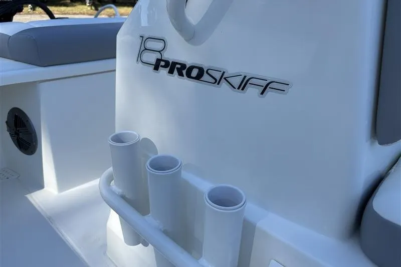 Slide: The Image of 2026 Mako 18 Pro Skiff boat interior with rod holders and logo detail. - 25