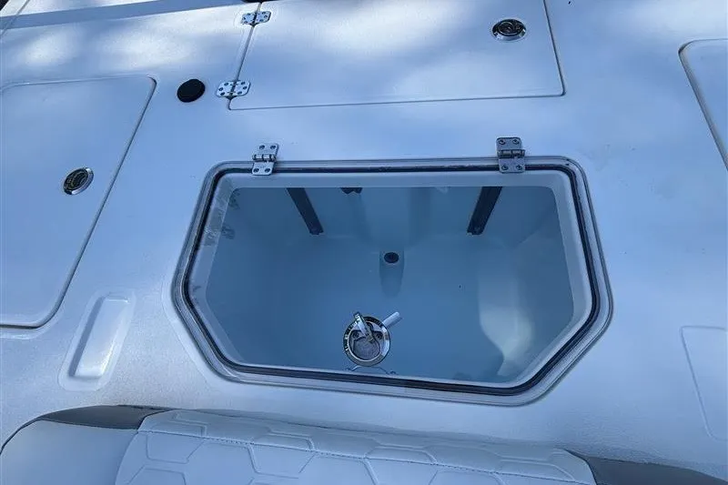 Slide: The Image of 2026 Mako 18 Pro Skiff boat deck with storage compartment and seating. - 22