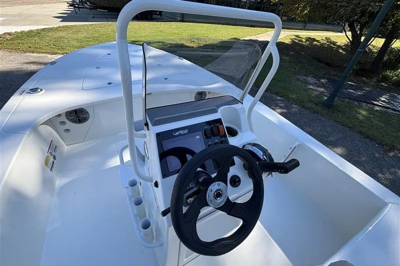 Slide: The Image of 2026 Mako 18 Pro Skiff boat interior with steering wheel and console controls. - 16