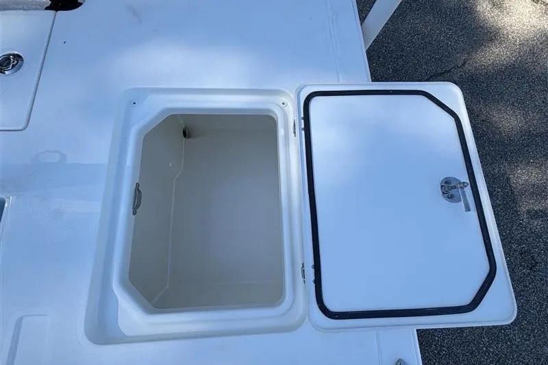 Slide: The Image of Open storage compartment on a 2026 Mako 18 Pro Skiff boat deck. - 23