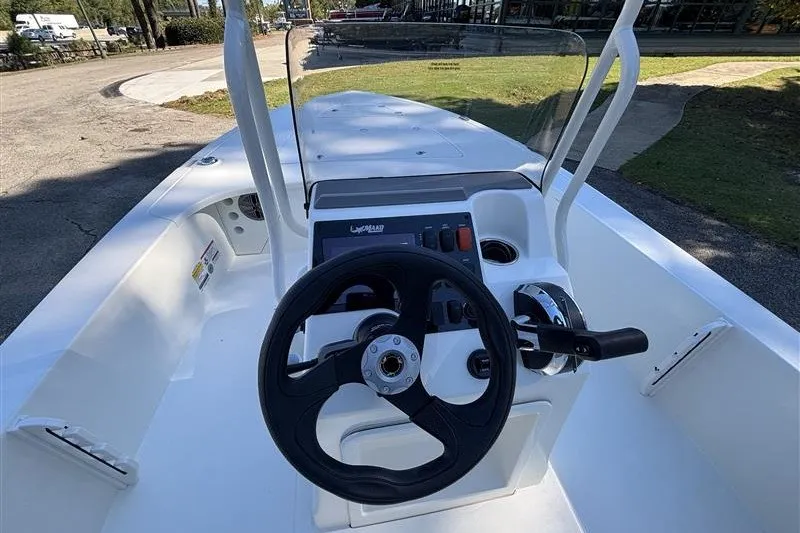 Slide: The Image of 2026 Mako 18 Pro Skiff boat interior with steering wheel and control panel. - 17