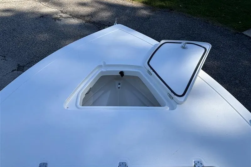 Slide: The Image of 2026 Mako 18 Pro Skiff boat with open storage compartment on deck. - 12
