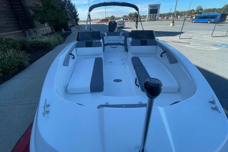 Slide: The Image of 2027 Tahoe T21 boat with spacious seating, parked outdoors in a lot. - 3