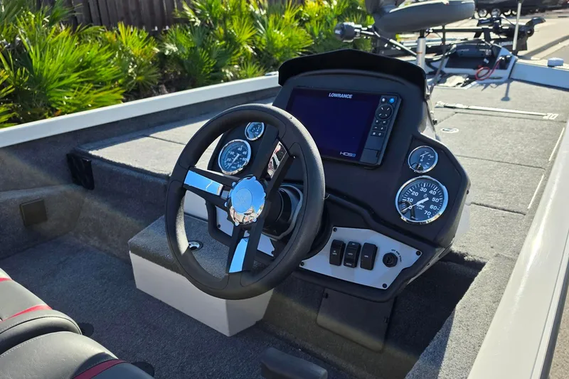 Slide: The Image of Cockpit of 2027 Ranger RT198P boat with steering wheel and navigation display. - 13