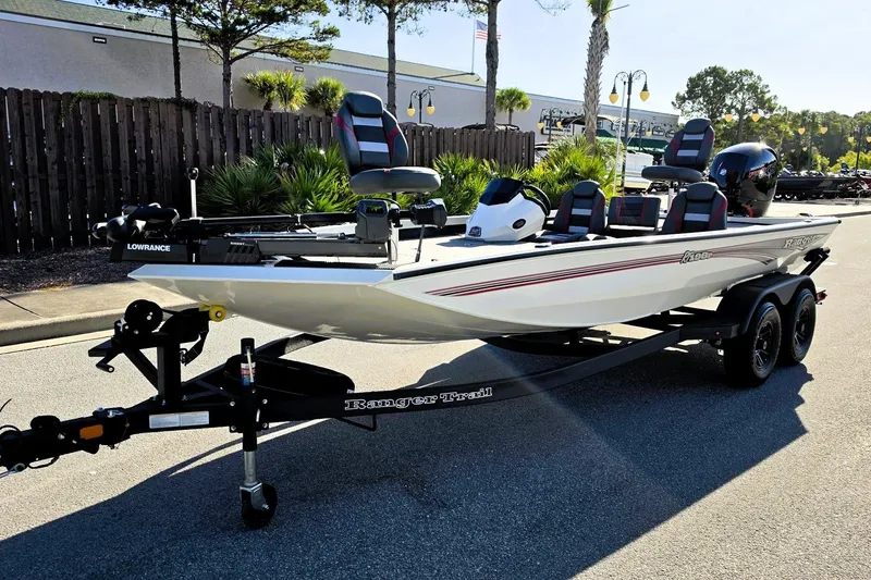 Slide: The Image of 2027 Ranger RT198P fishing boat on trailer, parked outdoors, featuring sleek design and modern equipment. - 10