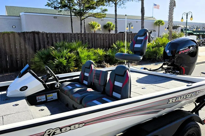 Slide: The Image of 2027 Ranger RT198P fishing boat with Mercury Pro XS engine, parked outdoors. - 19