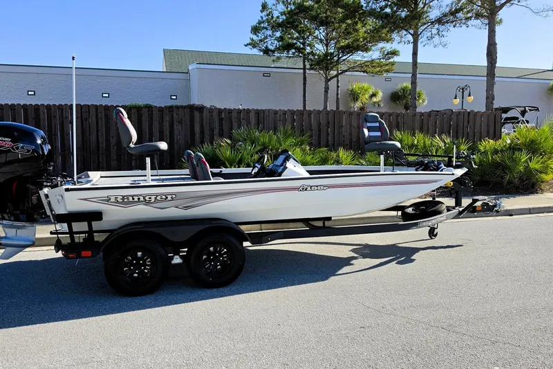 Slide: The Image of 2027 Ranger RT198P fishing boat on trailer, parked outdoors. - 3