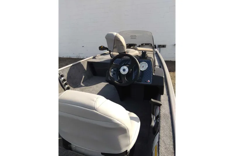 Slide: The Image of 2027 Tracker Bass Tracker Classic Limited boat interior with steering wheel and gauges. - 13