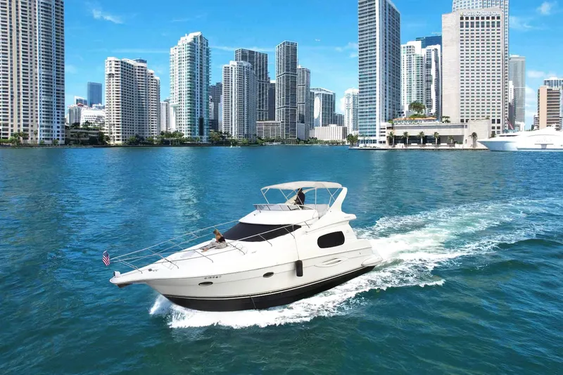 Slide: The Image of 2002 Silverton 410 Sport Bridge yacht cruising near city skyline. - 5