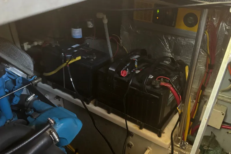 Slide: The Image of Engine room of a 2002 Silverton 410 Sport Bridge with batteries and wiring. - 53
