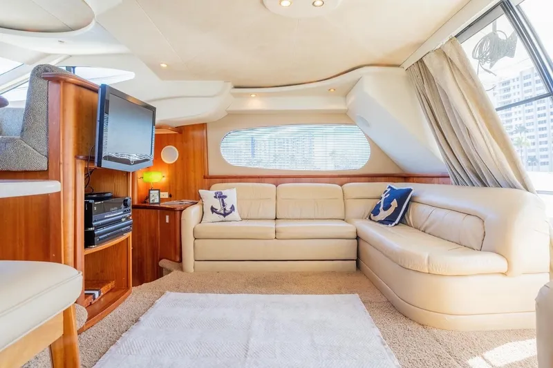 Slide: The Image of Luxurious interior of 2002 Silverton 410 Sport Bridge yacht with plush seating and entertainment system. - 16