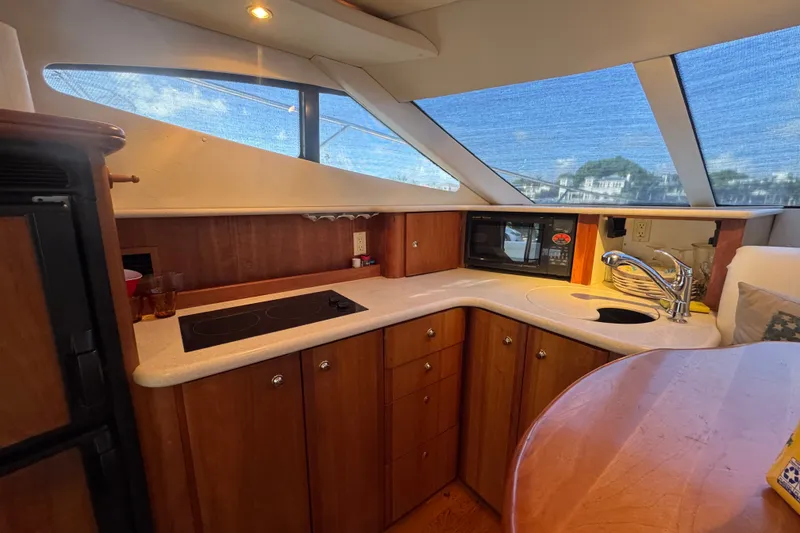 Slide: The Image of Luxurious 2002 Silverton 410 Sport Bridge yacht kitchen with modern amenities and scenic views. - 33