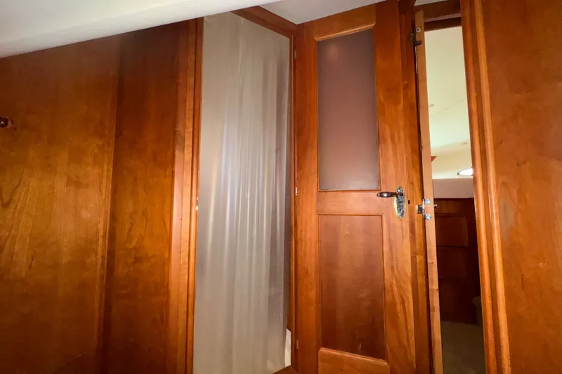 Slide: The Image of Interior view of 2002 Silverton 410 Sport Bridge with wooden doors and paneling. - 47