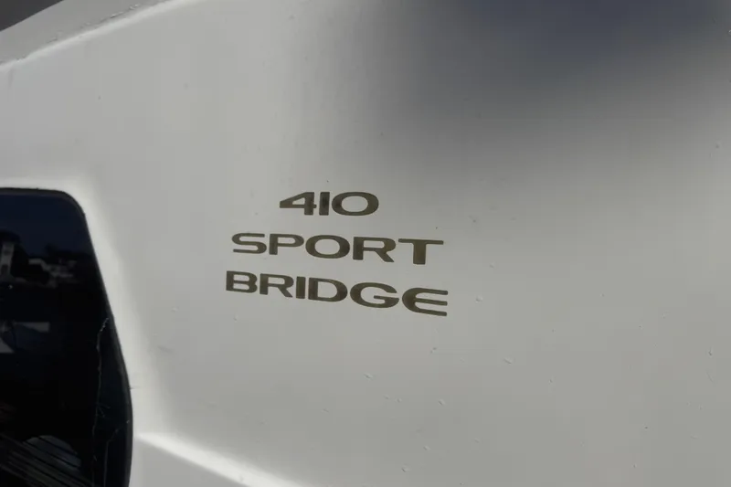 Slide: The Image of Close-up of 2002 Silverton 410 Sport Bridge model name on boat exterior. - 58