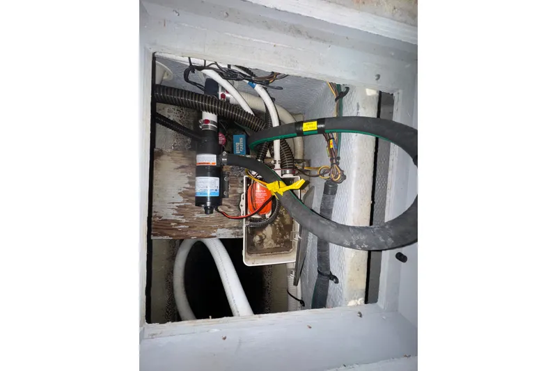 Slide: The Image of Engine compartment of a 2002 Silverton 410 Sport Bridge with visible hoses and wiring. - 60