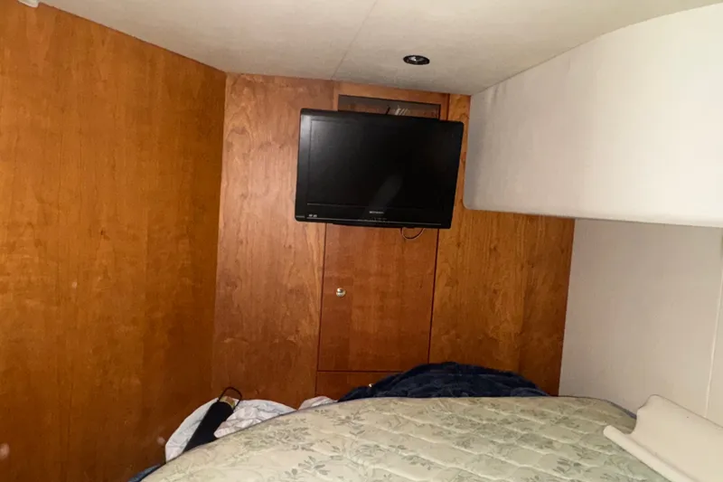 Slide: The Image of Interior cabin of 2002 Silverton 410 Sport Bridge with TV and bed. - 51