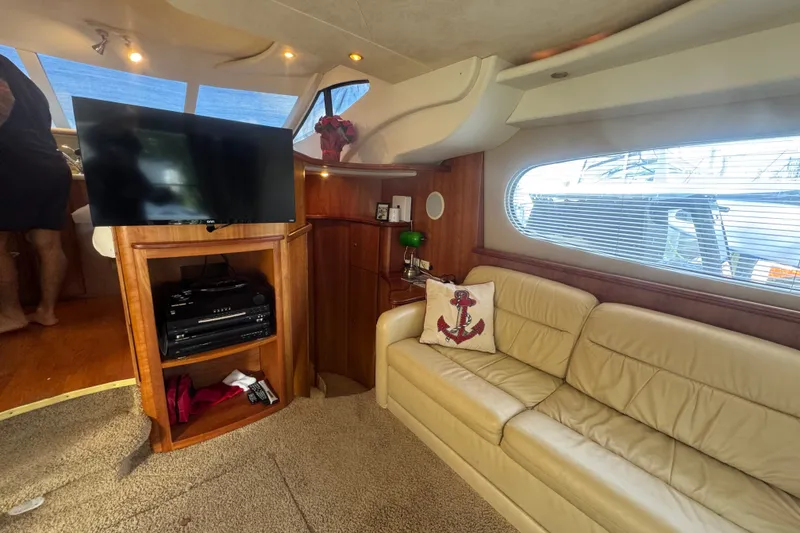 Slide: The Image of Luxurious interior of 2002 Silverton 410 Sport Bridge with leather seating and entertainment center. - 30
