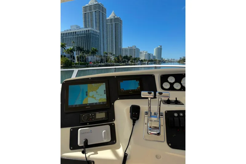 Slide: The Image of Cockpit view of 2002 Silverton 410 Sport Bridge with city skyline in background. - 20