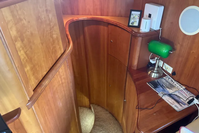Slide: The Image of Interior of 2002 Silverton 410 Sport Bridge with wooden staircase and desk area. - 39